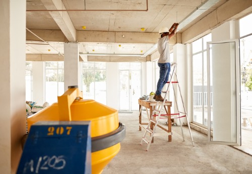 A builder setting up lighting during Interior Contracting in Peoria IL