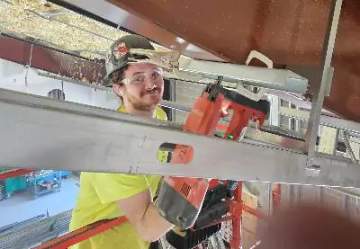 A worker is seen on an interior contracting job. Mid-Illinois Companies does commercial construction in Bloomington IL.